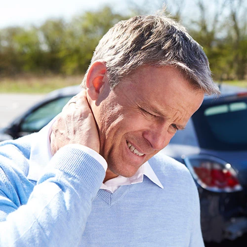 A Man who has just been in an accident is showing signs of neck pain and whiplash